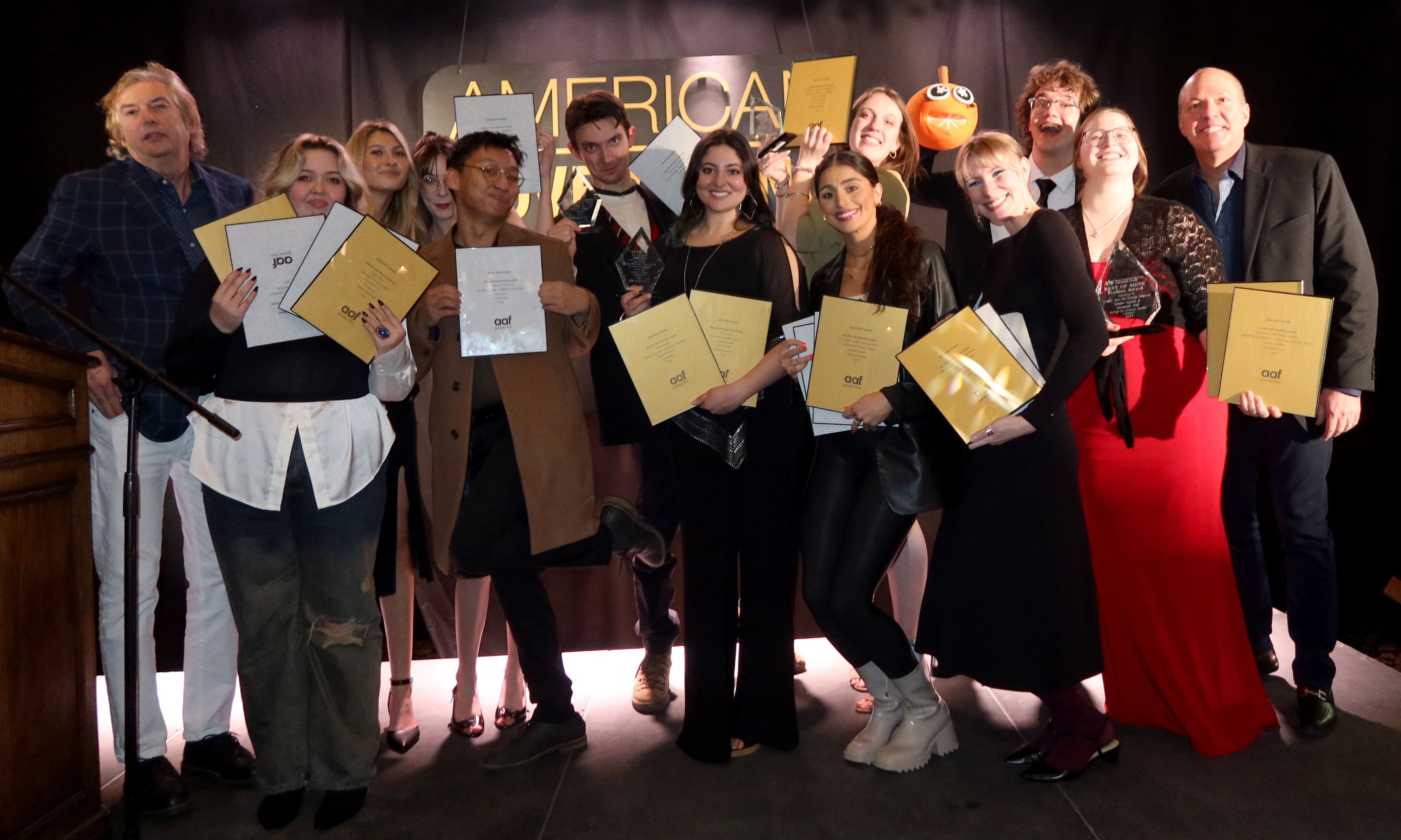 students gather with their awards at the ADDY awards
