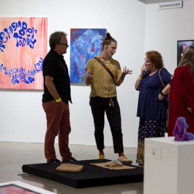 people talking in the manoogian gallery during the student exhibition opening