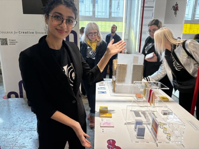 Yostina Kaoud '24, Color and Materials Design, poses with their work for a Color and Material Design Project at Milan Design Week.