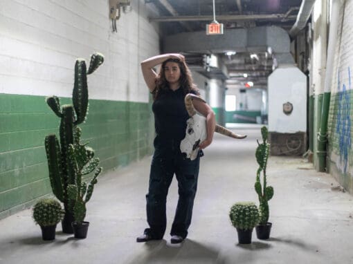 CCS Alumni Ilana Portney posing in the hallways of Detroit's Russell Center.