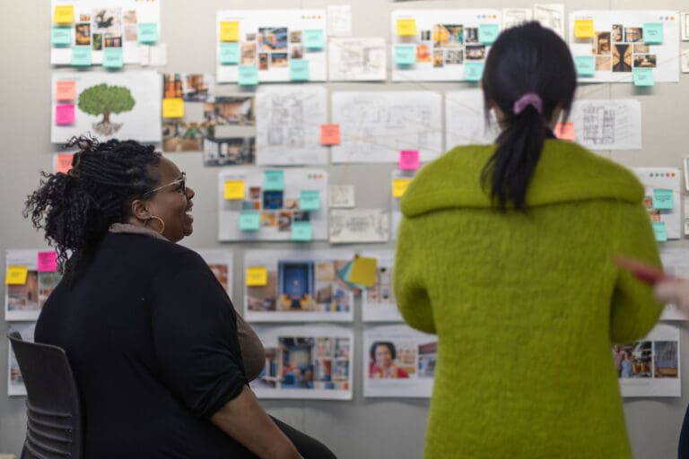 Vivyan Zhang ('24, MA CMD) presents a design board to a C.L.A.S.S. staff member.