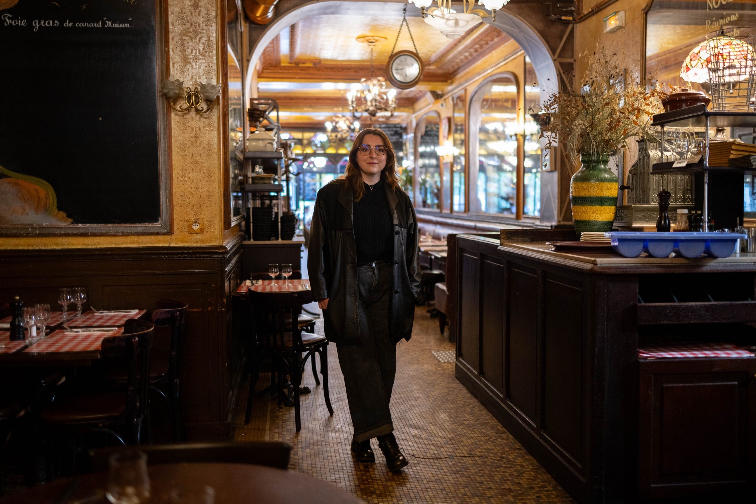 Camille Guellec standing in a cafe.