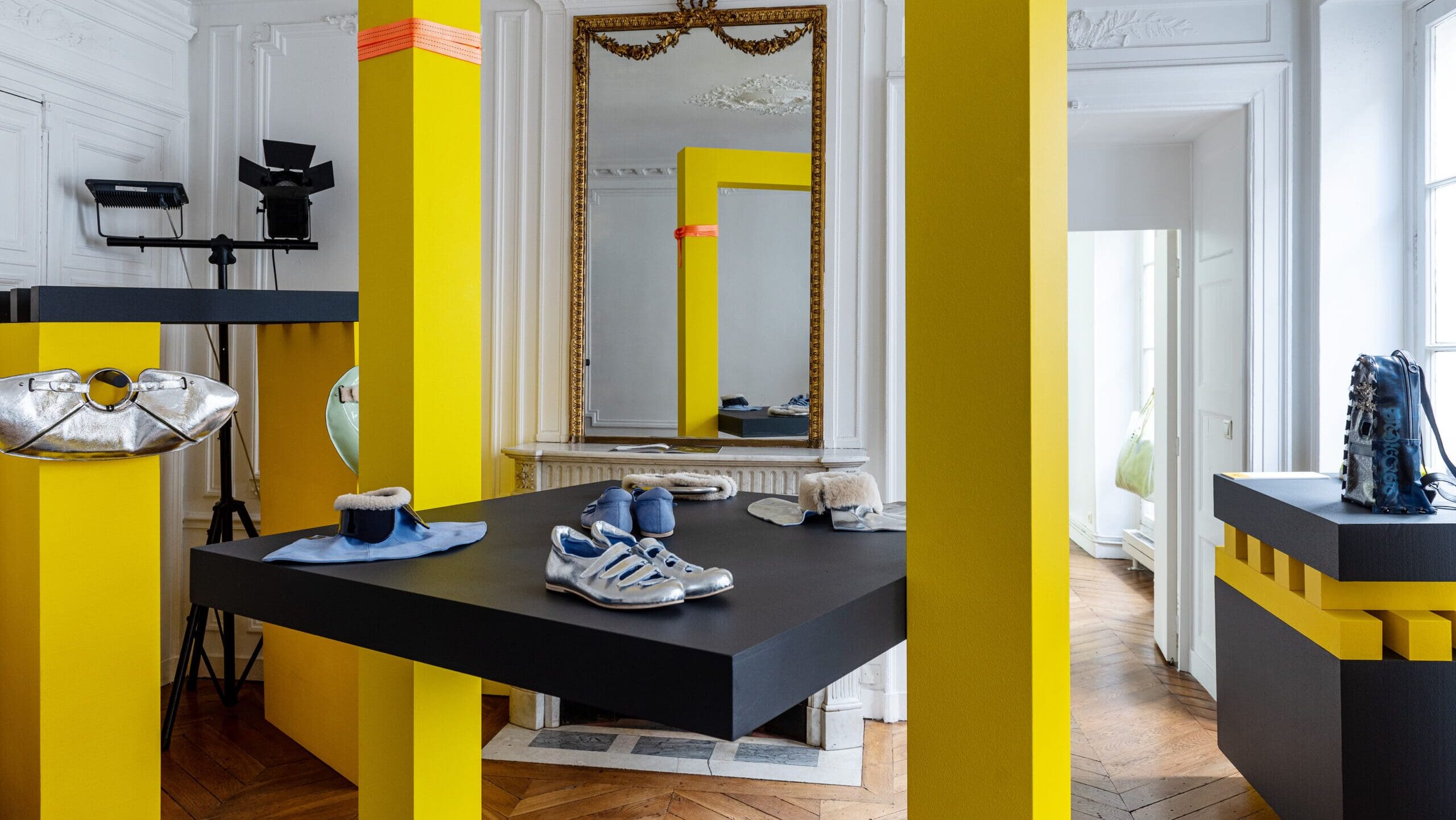 Paris showroom fashion showroom with yellow pillars and shoes on a table