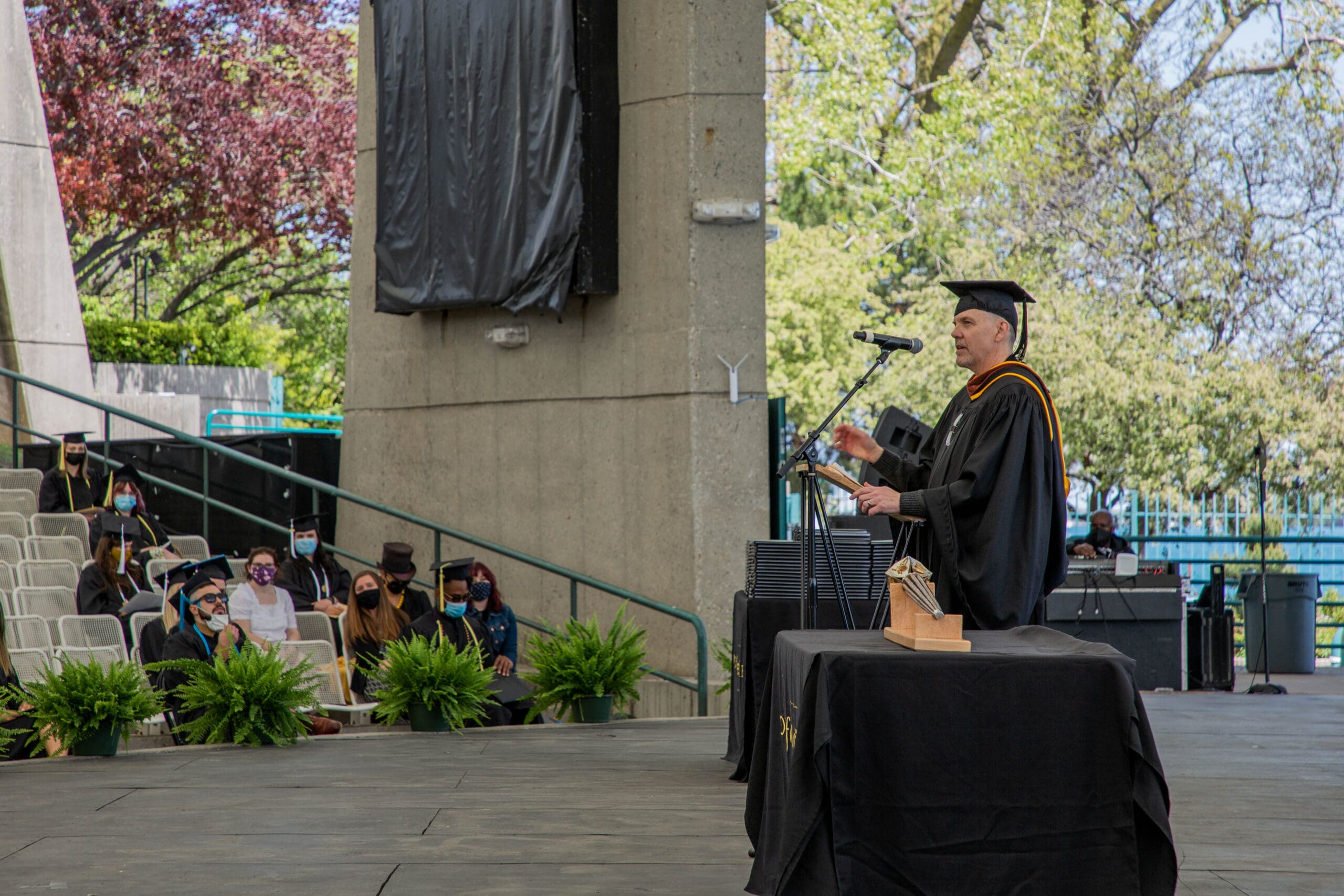 Tim Flattery - Commencement Tim Flattery, CCS provost speaks at the commencement ceremony wearing a cap and gown