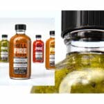 A split image of hot sauce bottles. The left side shows a row of five different colored bottles of Hell Fire hot sauce. The right side is a close-up, bottom-up view of the green hot sauce bottle.