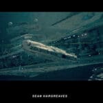 Illustration of an Imperial Star Destroyer and Tie Fighters shooting lasers at the Millennium Falcon on a background of starry outer space.