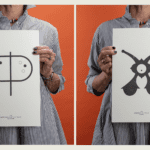 Two posters displaying abstract symbols labeled "papilionaceous" and "enceinte" held against an orange background.