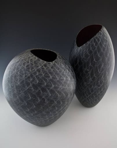 "Pat with 6 of her 12 Children - Pontiac Michigan" Black-and-white photograph by Glenn Triest featuring a woman seated on a couch, surrounded by six children engaged in various activities around the room.