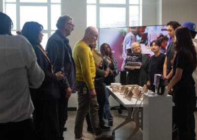 A group of students presenting their project to a group of judges at the College for Creative Studies