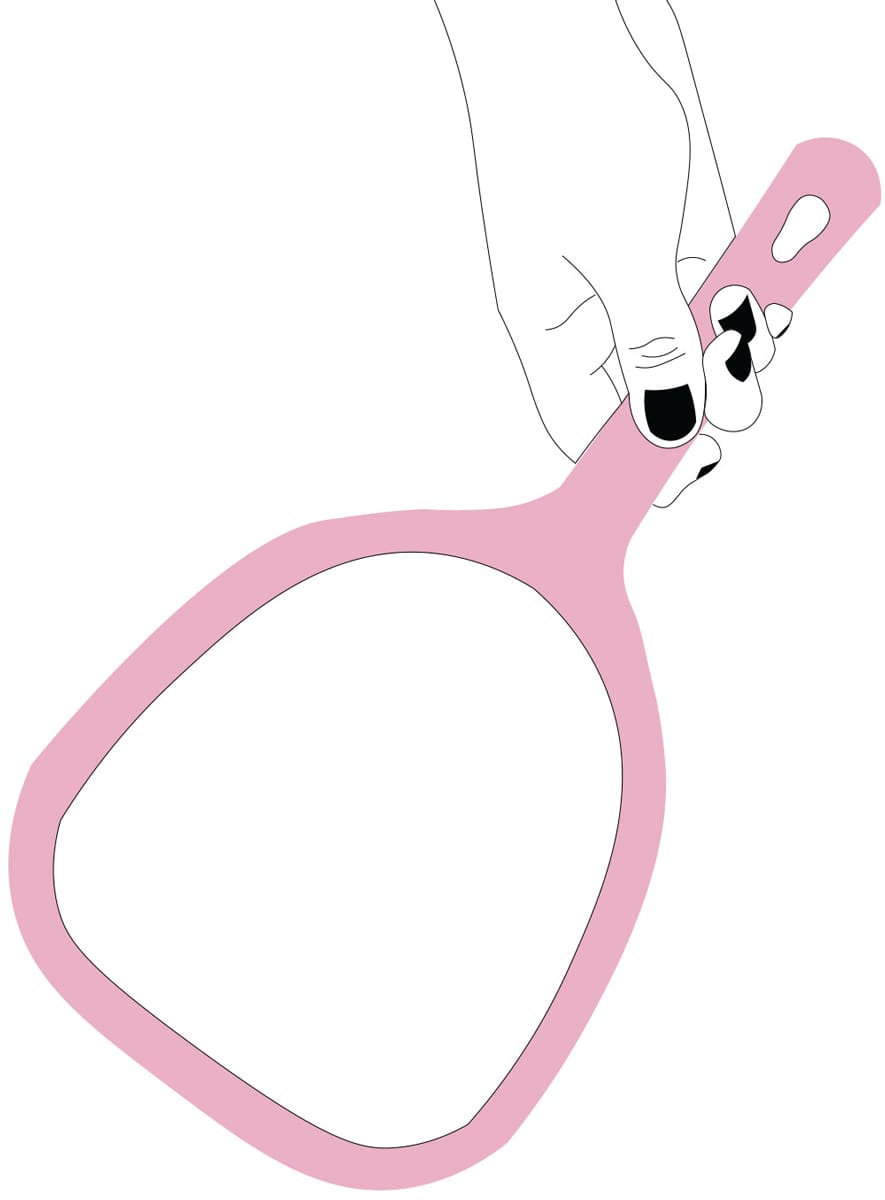 a hand with black nails holding a pink mirror