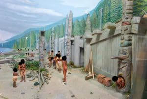 a tribe of people by a body of water with their faces censored