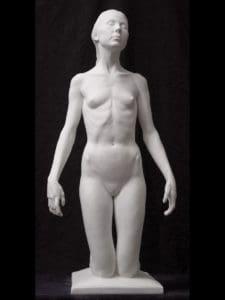 a small woman on her knees with her eyes closed