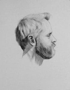 side profile of a man with short hair and a full beard