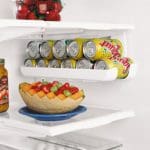 fruits and canned pop inside of a fridge