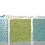Three blue and yellow semi-transparent sheets of glass with geometric patterns