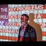 Photo of a smiling man in front of a projection of the American flag made up of red, white, and blue photos of Donald Trump, and white text reading one of his quotes.