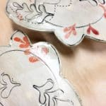 two plates with a repeating red and black leaf pattern