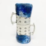 two blue and white mugs with black repeating vertical circles