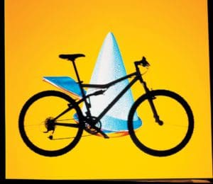 a bike in shadow against a yellow background