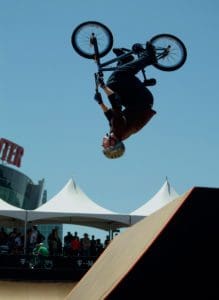 a person doing a backflip on a bmx bike